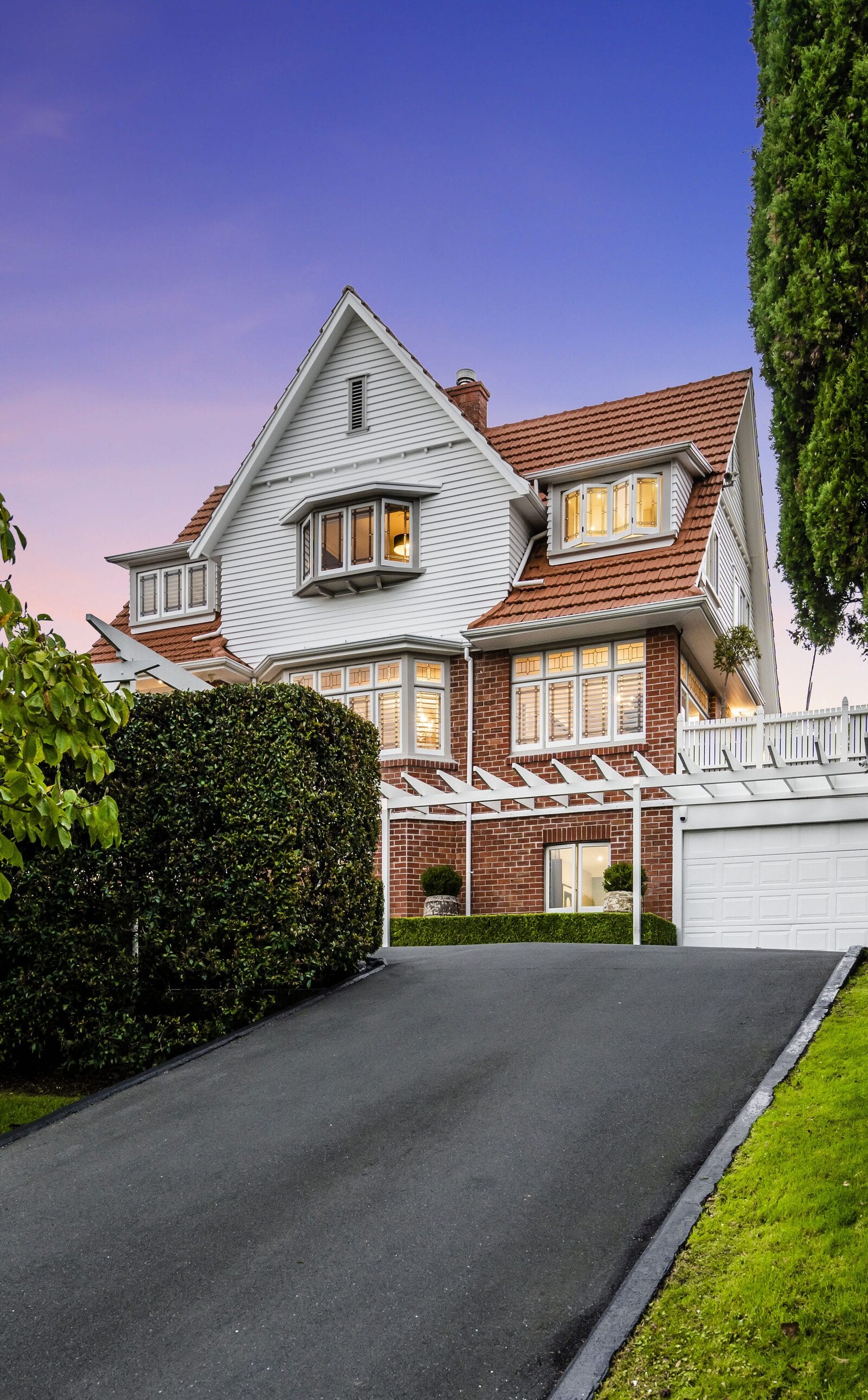 44 Entrican Avenue at dusk, a gabled brick and weatherboard home above its drive